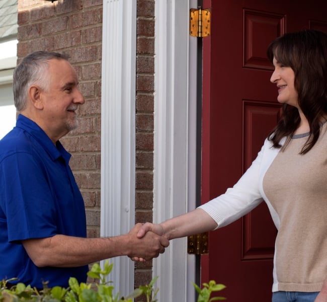 A VELUX Partner greets the homeowner on a service visit.